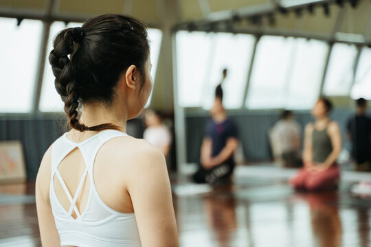 Young women practice yoga in a yoga studio