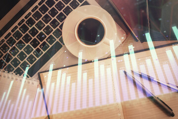 Stock market chart and top view computer on the table background. Double exposure. Concept of financial analysis.