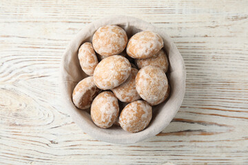 Tasty homemade gingerbread cookies on white wooden table, top view