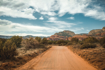 gravel road leading through mountains