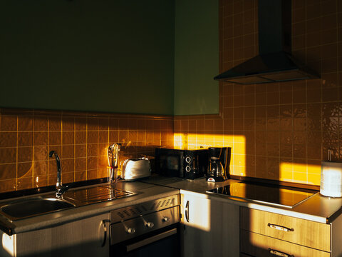 Interior of kitchen lit by sunlight