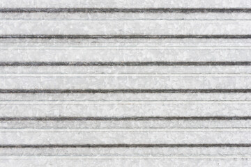 Corrugated metal sheet background. Grunge old grainy metal texture. Silver color industrial pattern. Garage construction gray striped wall.