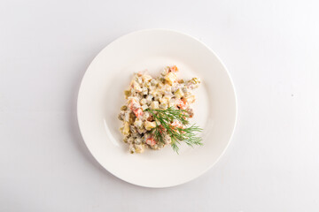Top view on isolated russian national olivier salad on white