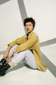 Androgynous model in shadow of window