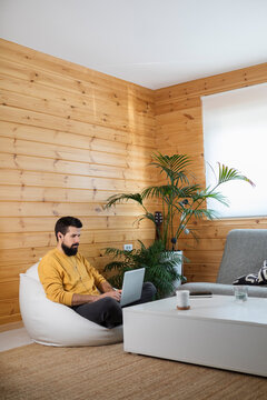 Man Working on Laptop from comfort of his Home