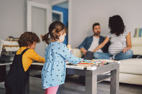 Children playing while their parents watch them