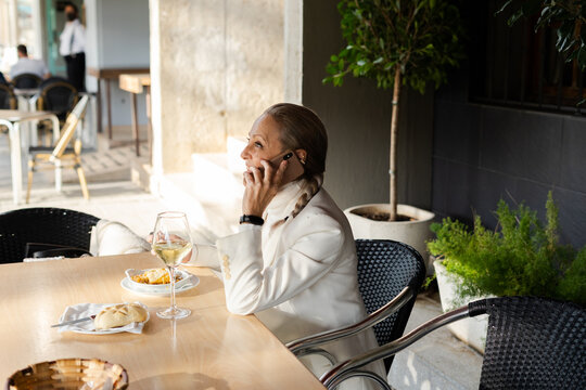 Business Woman Talking By Phone At Restaurant