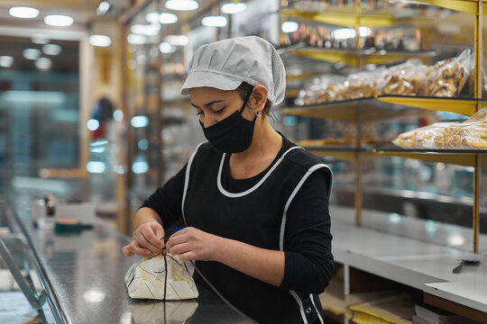 Woman serving in bakery