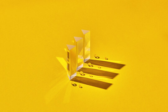 Abstract set of glass prisms with reflection and shadows.