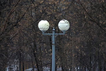 Fototapeta na wymiar a lamp with two plafonds among the trees