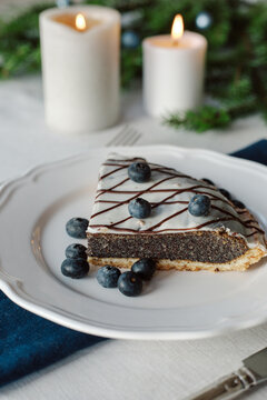 Poppy seed cake with icing garnished with blueberries