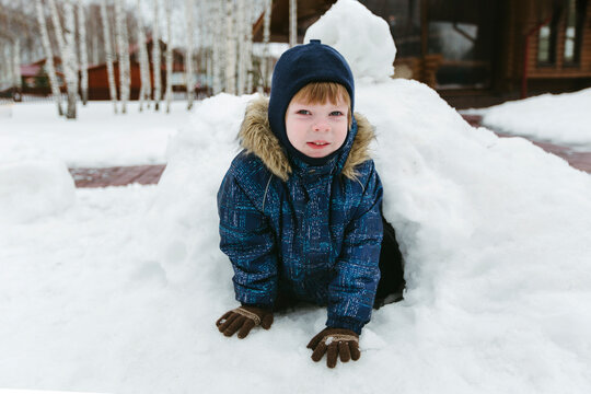 A child plays outside in winter.