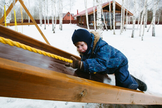 A child plays outside in winter.
