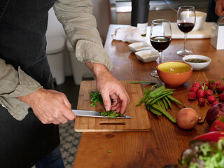 Cook cutting herbs.