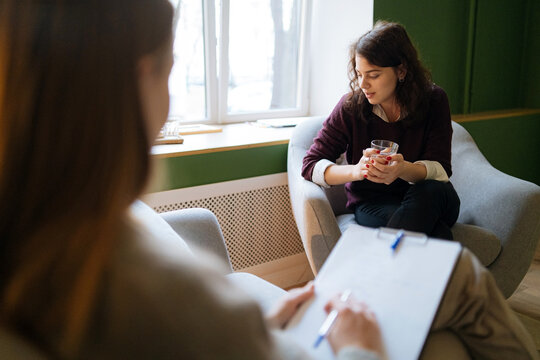 young woman talks about her problems to a psychologist