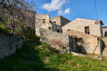 Fototapeta na wymiar entrances and facades of old decaying houses ruins of a ghost town in Italy