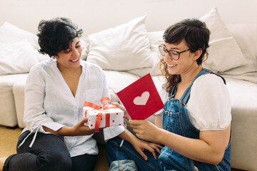 Lesbian couple with gift and valentines card