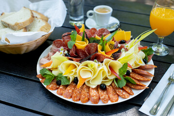 details of delicious outdoor brunch on black wooden table