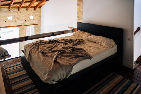 Unmade bed in modern apartment