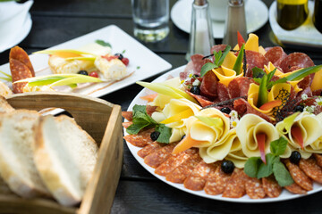details of delicious outdoor brunch on black wooden table