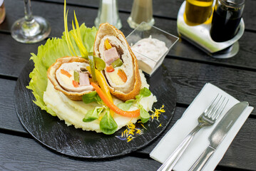 details of main course, outside on a wooden table