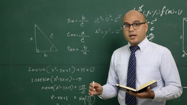 Young asian teacher man teaching video conference with student. Male Indian teacher training the mathematics in classroom from online course.