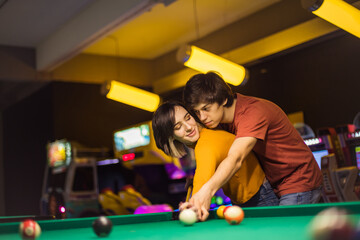  Boyfriend teaching his girlfriend to playing billiard.
