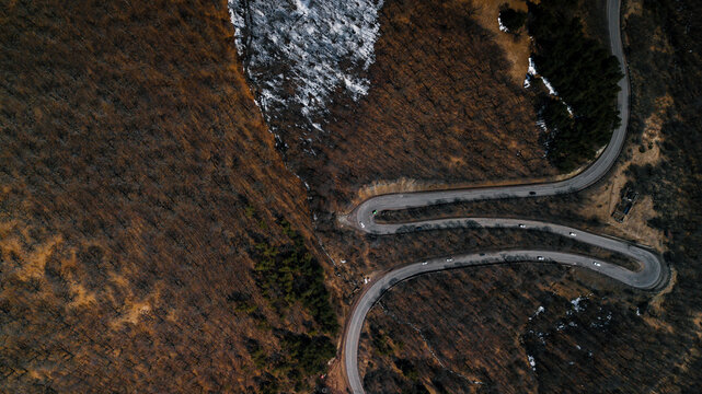 Overhead shot of a switchback road in the mountains