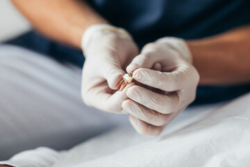 A Dentist Holding an Artificial Tooth