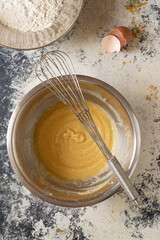 Making some cookies: cookie dough in the making, with a wisk and a spoon