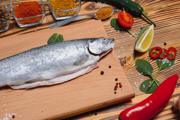 fresh trout with spices and seasonings top view, flat lay