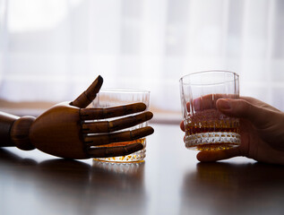 Whiskey glass in hand. Whiskey glass. Hand. Photo. 