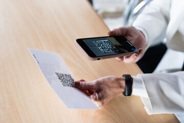 senior business woman reading QR code of the menu restaurant with phone