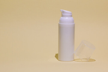 Cream, serum bottle on yellow background