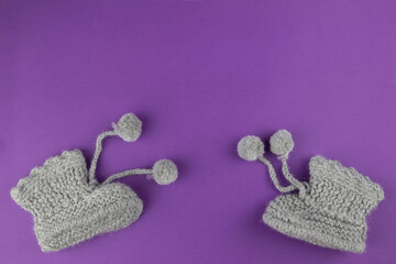 children's winter boots on a bright purple background
