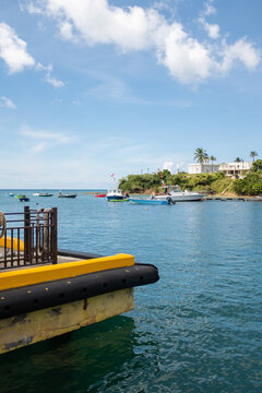 Empty yellow dock overlooking boats in the island