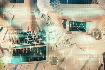 Multi exposure of man and woman working together and forex graph hologram drawing. Financial analysis concept. Computer background. Top View.