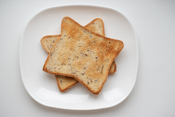 two golden brown toast for breakfast on a white plate