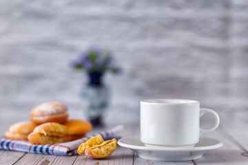 A cup of freshly brewed tea with lemon biscuits. Selective focus.