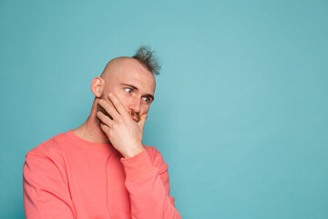 Bearded european man in casual peach isolated on turquoise background thinking worried about a question, concerned and nervous