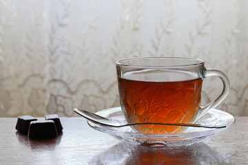 Tea in a transparent cup on a saucer.