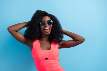 Photo portrait of girl laughing overjoyed in dress smiling dancing on holidays in sunglass isolated bright blue color background