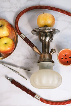 Glass arabian smoking hookah shisha  with apple flavor on a white background