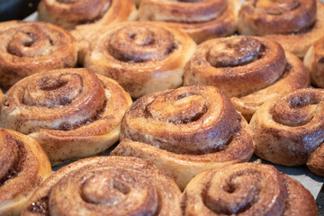 Beautiful homemade cinnamon rolls fresly baked. Yummy food, delicious pastry but each roll is containing a lot of calories.