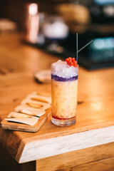 Beautiful alcoholic cocktails on wooden bar counter and cheese snack