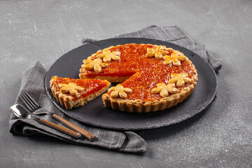 Side view on pumpkin tart on the grey concrete background