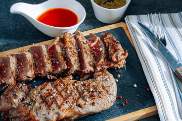 juicy fresh fried steaks for dinner. two fried striploin steak in a medium roasting rare