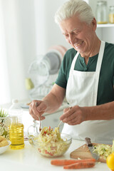 elderly making salad at kitchen