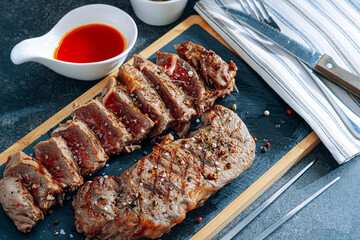 juicy fresh fried steaks for dinner. two fried striploin steak in a medium roasting rare