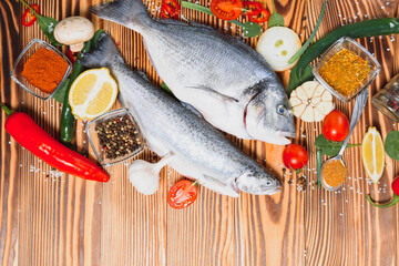 Raw dorado and trout fish with spices cooking on cutting board. Fresh fish dorado
